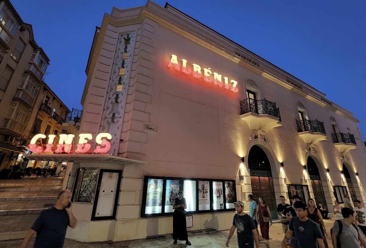 The Albéniz Cinema on Calle Alcazabilla in Málaga, lit up at dusk