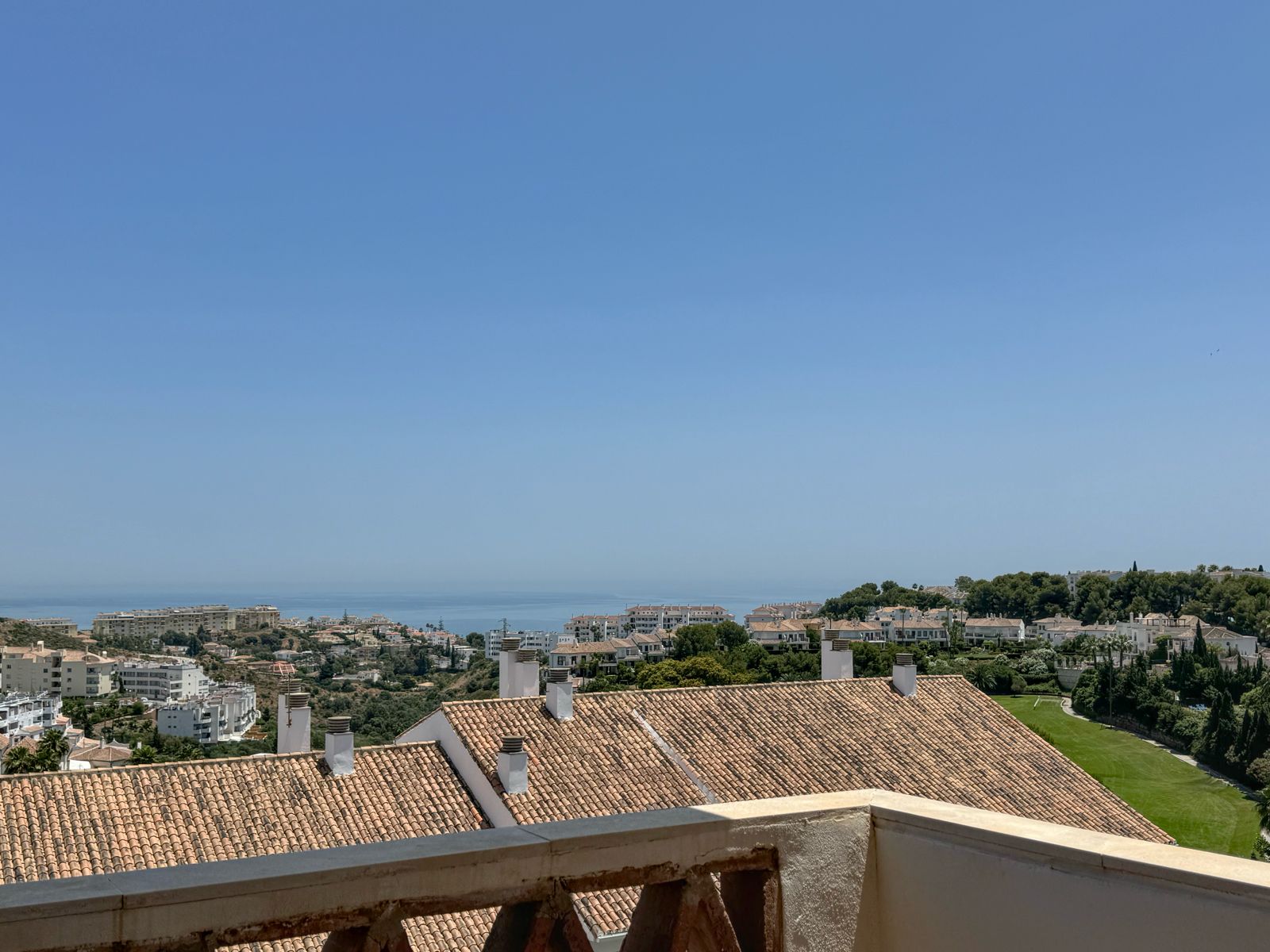 Panorama from the master balcony — the sea ahead, the golf course to the side